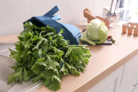 Eco bag with fresh products on counter in kitchenの写真素材