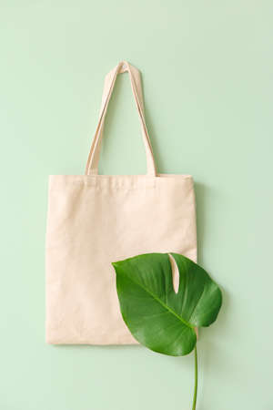 Eco bag with tropical leaf on color backgroundの写真素材