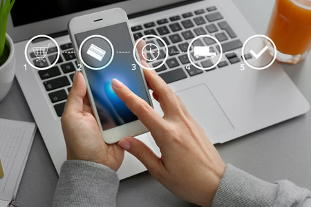 Woman with mobile phone using delivery service applicationの写真素材