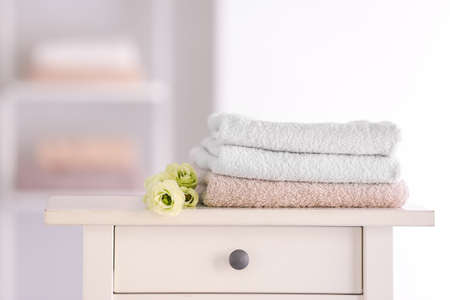 Soft clean towels on table in bathroomの写真素材