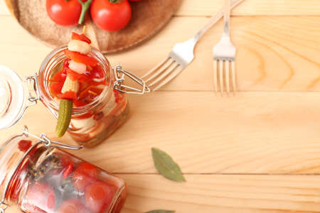 Jars with canned vegetables on wooden tableの写真素材