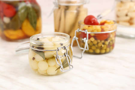 Jar with canned onion on light table