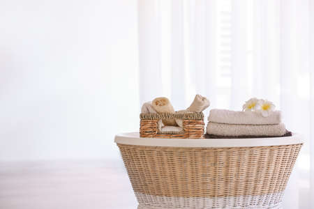 Soft clean towels with accessories on table in bathroomの写真素材