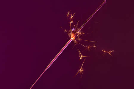 Festive Christmas sparkler on dark backgroundの写真素材