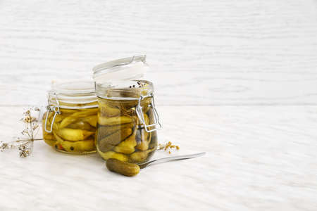 Jars with canned vegetables on light tableの写真素材