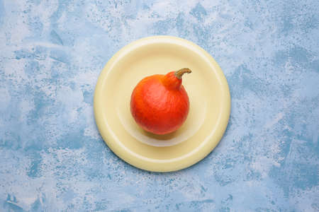 Plate with fresh pumpkin on color backgroundの写真素材
