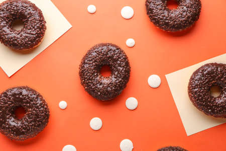 Sweet tasty donuts on color background
