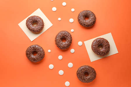Sweet tasty donuts on color background