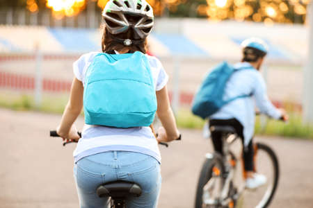Cute children riding bicycles outdoors