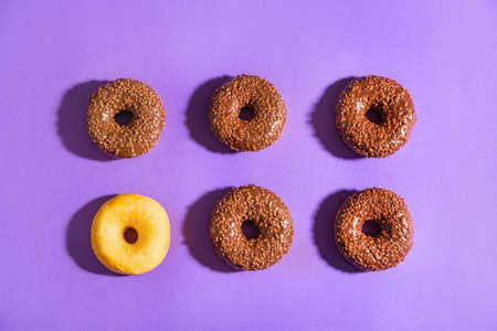 Tasty donuts on color background. Concept of uniqueness