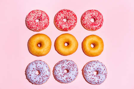 Sweet tasty donuts on color backgroundの写真素材