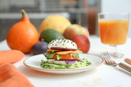Plate with tasty salad on table