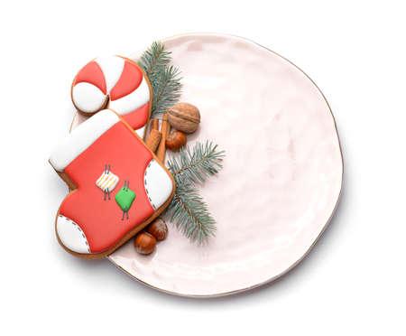 Plate with tasty Christmas cookies on white backgroundの写真素材
