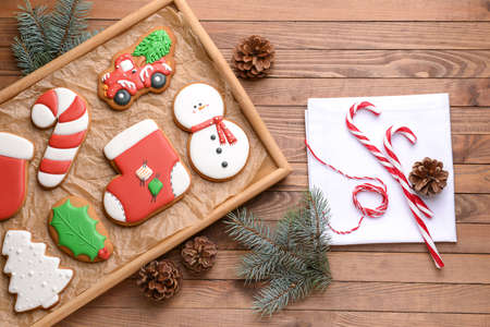 Tray with tasty Christmas cookies on wooden table