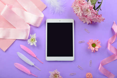 Modern tablet computer and accessories on workplace of florist