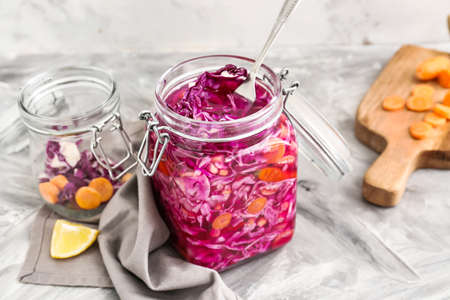 Jar with canned cabbage on table