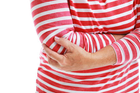 Mature woman suffering from pain in elbow on white background, closeup