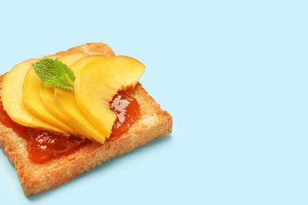 Tasty toasted bread with fruit jam on color backgroundの写真素材