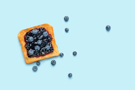Tasty toasted bread with berry jam on color backgroundの写真素材