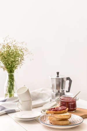 Plate with toasted bread and sweet jam on white tableの写真素材