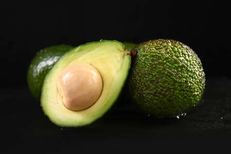 Ripe avocados on dark table