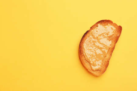 Tasty toasted bread with peanut butter on color backgroundの写真素材