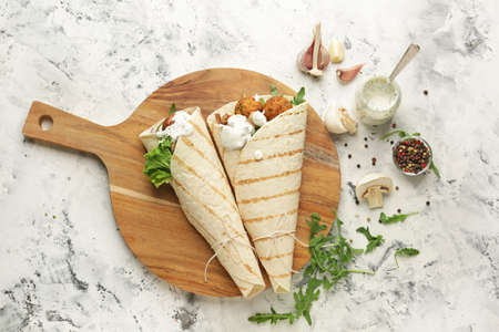 Tasty falafel pitas on light tableの写真素材