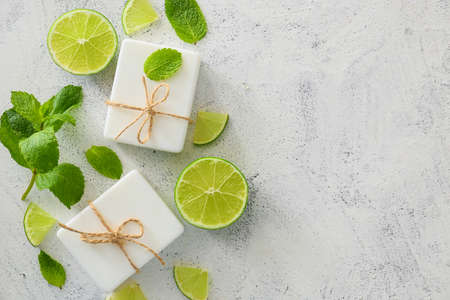 Soap bars, lime and mint on light backgroundの写真素材