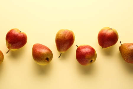 Sweet ripe pears on color background