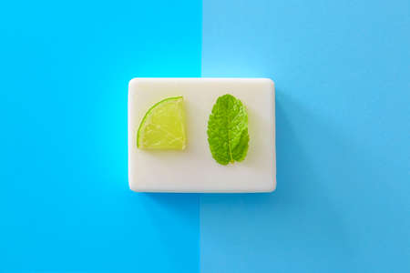 Soap with lime and mint on color backgroundの写真素材