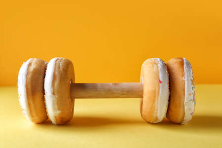 Creative composition tasty donuts on color backgroundの写真素材