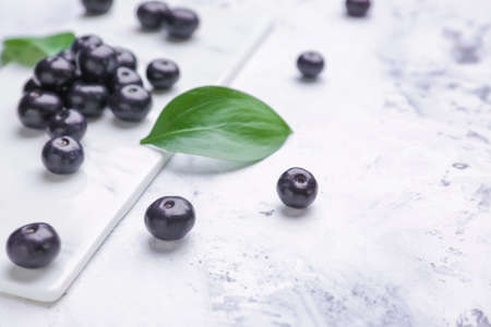 Fresh acai berries on white background