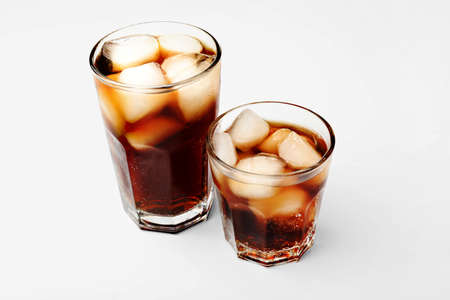 Glasses of cold cola on white background