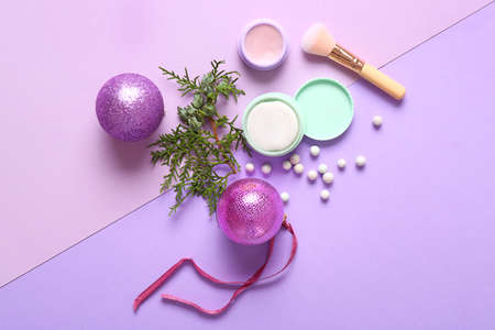 Set of cosmetics with Christmas decor on color backgroundの写真素材