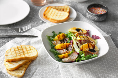 Plate with tasty salad on tableの写真素材