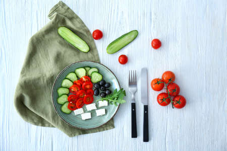 Plate of tasty vegetable salad with feta on tableの写真素材