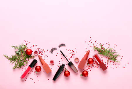 Set of cosmetics with Christmas decor on color backgroundの写真素材