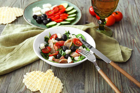 Plates with tasty salads on tableの写真素材