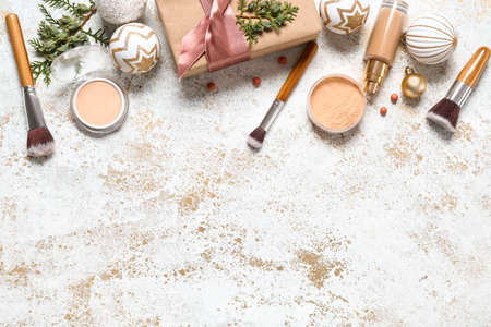 Set of cosmetics with Christmas gift on light backgroundの写真素材