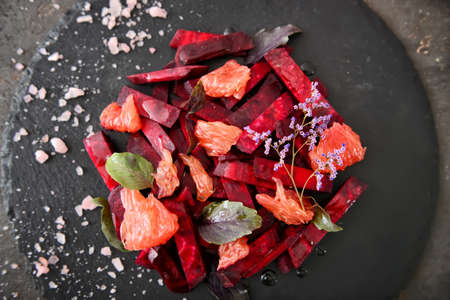 Tasty salad on slate plate, top view