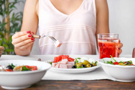 Woman eating fresh salad at table, closeupの写真素材