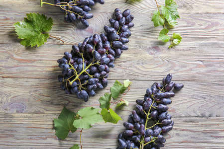 Tasty sweet grapes on wooden table