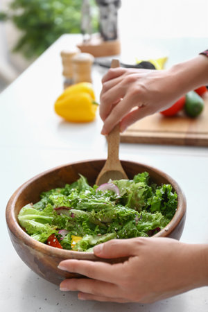 Woman preparing fresh salad at table, closeupの写真素材