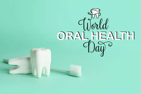 Teeth with toothbrush on color background. World Oral Health Dayの写真素材