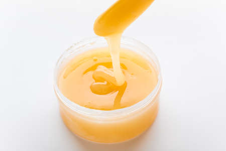 Sugaring paste for hair removal on white background