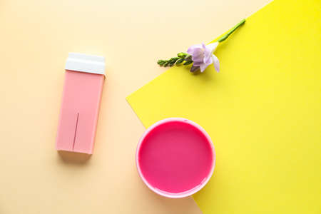 Liposoluble wax cartridge, sugaring paste and flowers on color backgroundの写真素材
