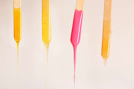 Sticks with dripping sugaring paste on light backgroundの写真素材