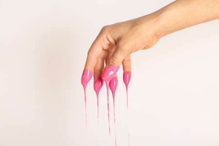 Female hand in sugaring paste on light backgroundの写真素材