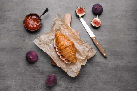 Sweet croissant and fig fruit slices on gray backgroundの写真素材