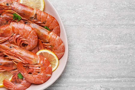 Plate with tasty shrimps on light tableの写真素材